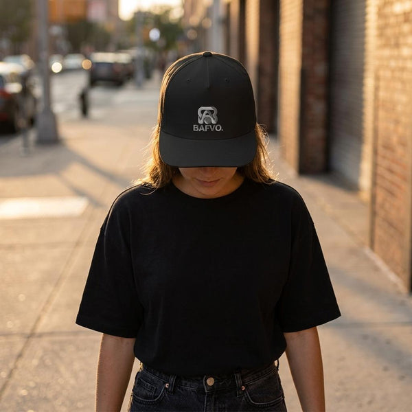 Model wearing THE BLACKOUT black surf cap with BAFVO logo outdoors, Toronto streetwear